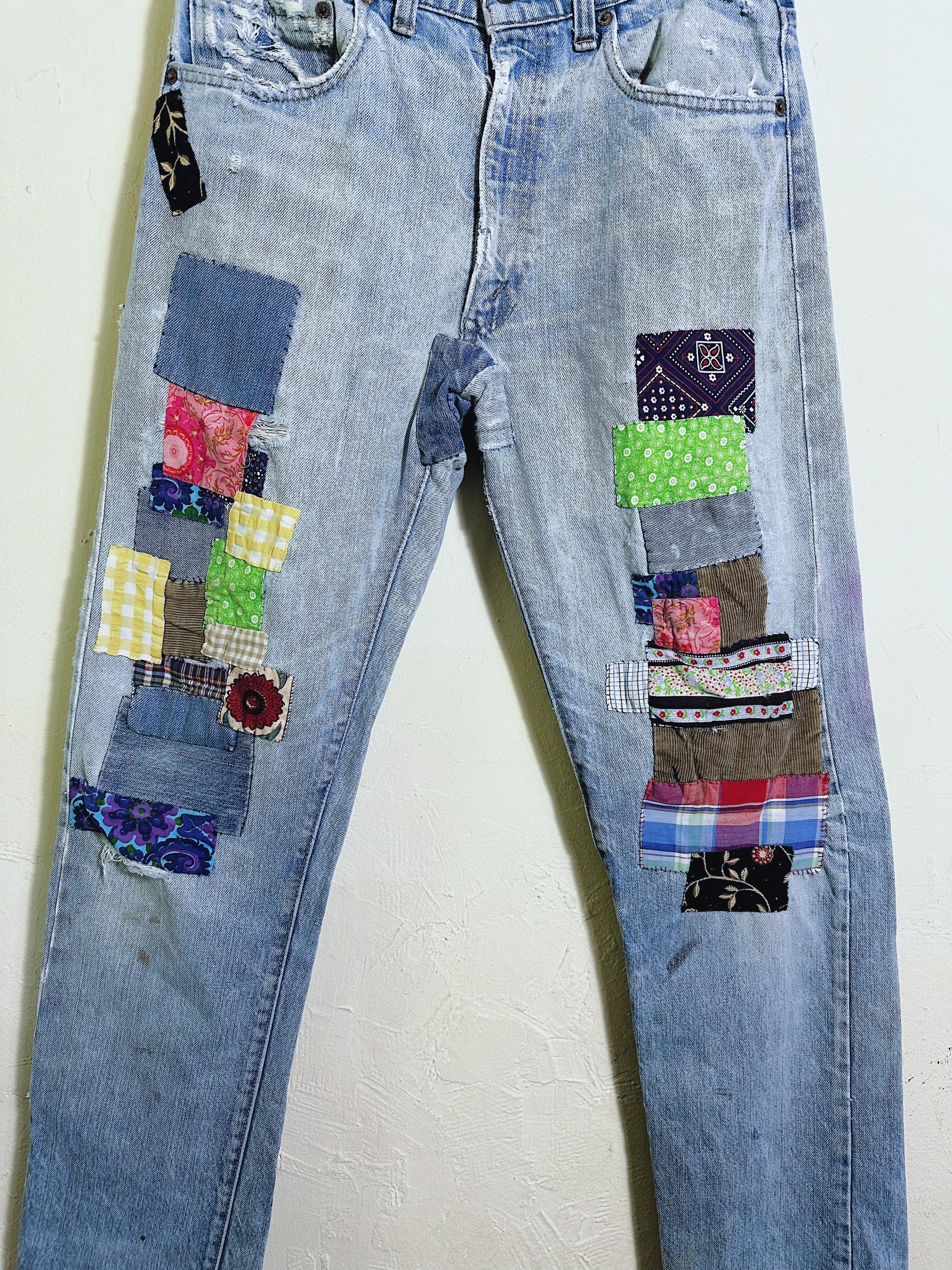 Levis 501 Patched denim jeans front patch close up on legs 