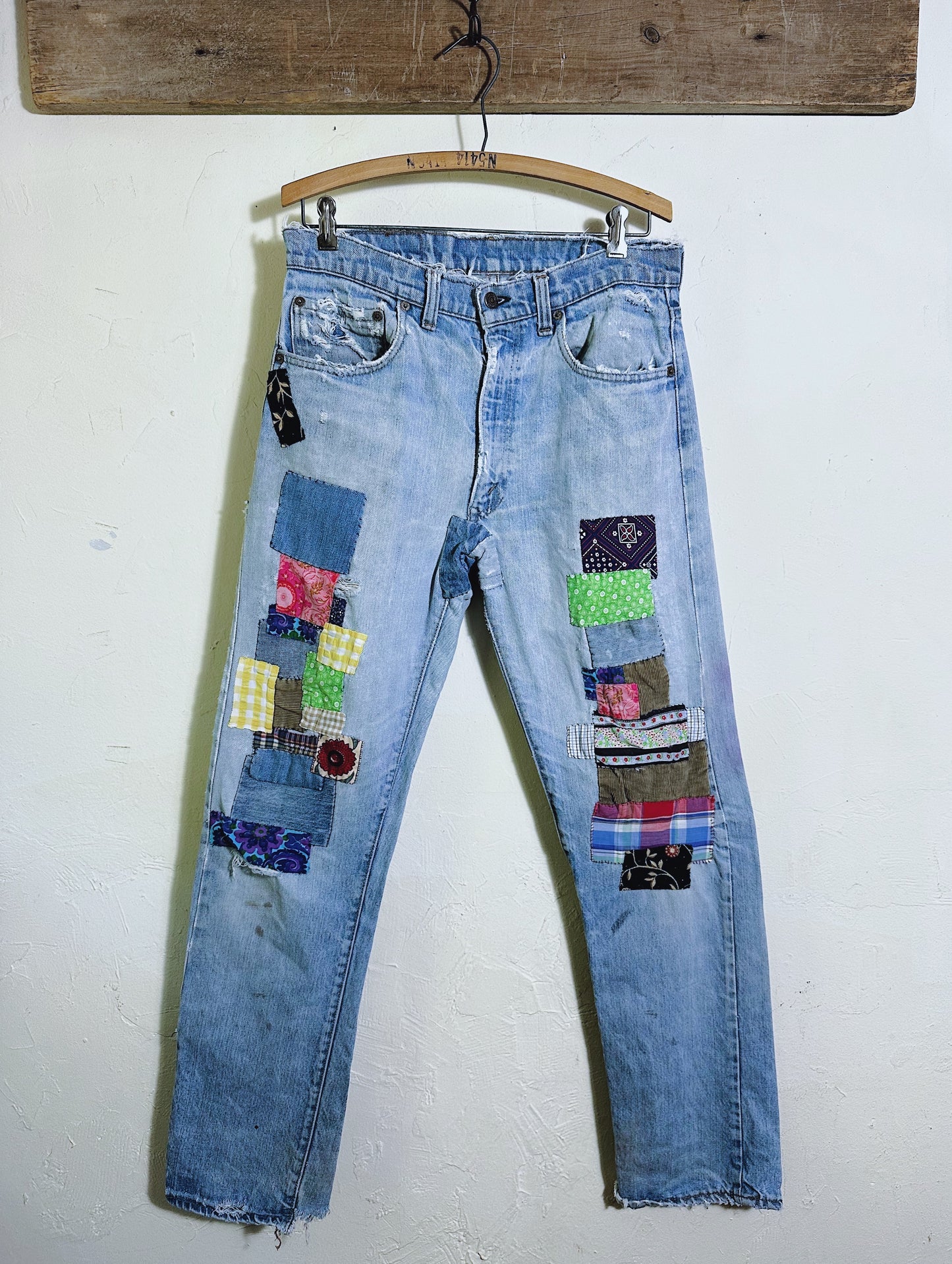 Levis 501 Patched denim jeans front view with different colored patches 